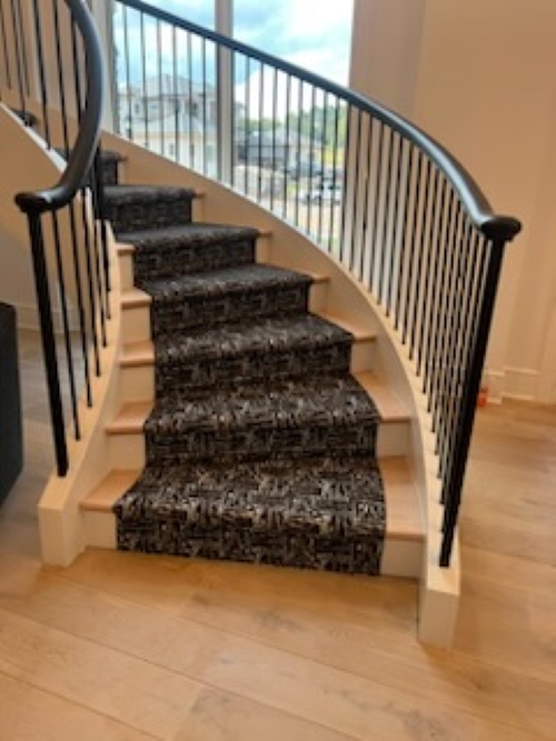 Dramatic staircase with custom carpet runner.